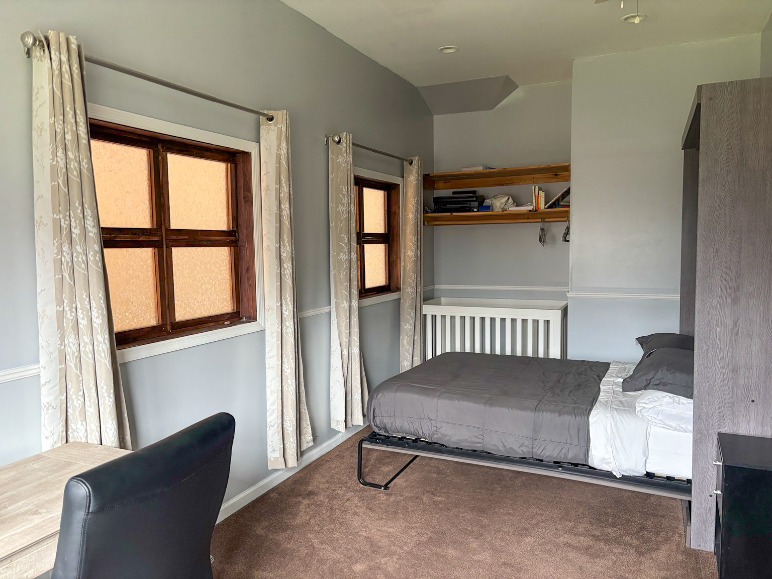 Fifth bedroom with a double bed, desk, and crib