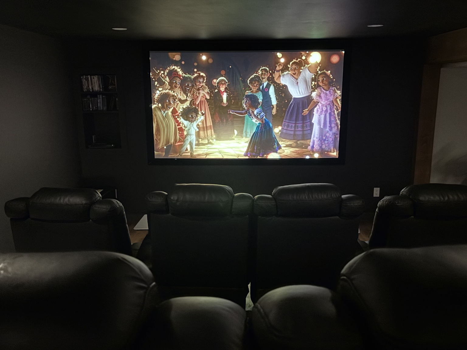 The complete 100-inch 4K movie screen viewed from behind the theater seating