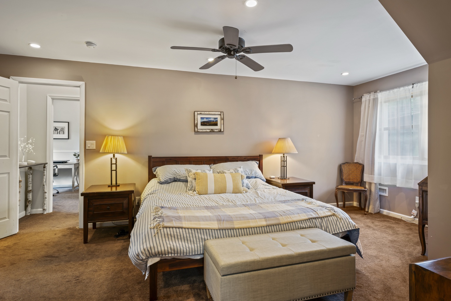 Spacious primary bedroom with king bed and adjoining spaces
